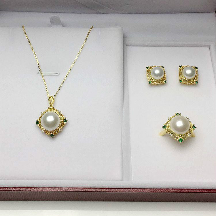 Pearl jewelry set with necklace, earrings, and ring in a box