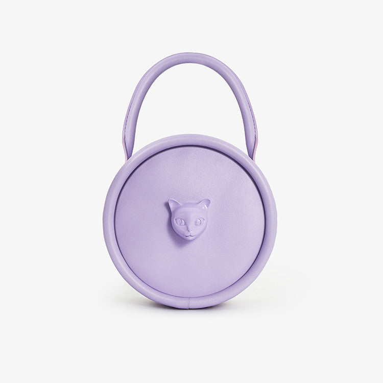 Purple round container with a handle and bear emblem on a white background