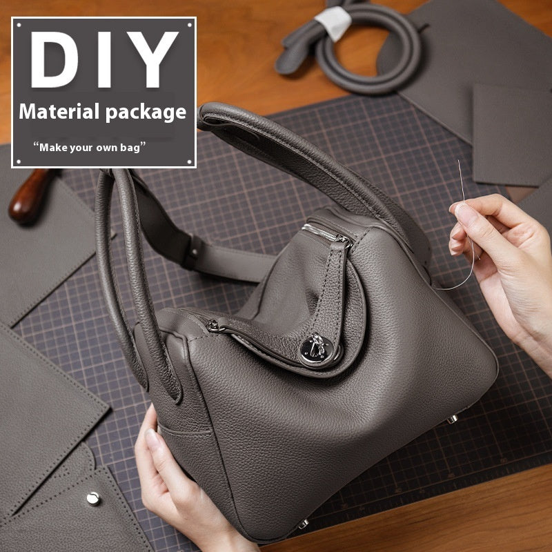 Gray handbag with sewing materials and text 'DIY Material package Make your own bag' on a wooden surface.