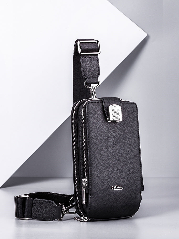 Black crossbody bag with visible brand logo on a gray background