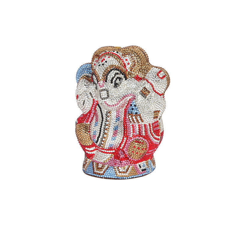 Colorful elephant head figurine with decorative patterns on a white background