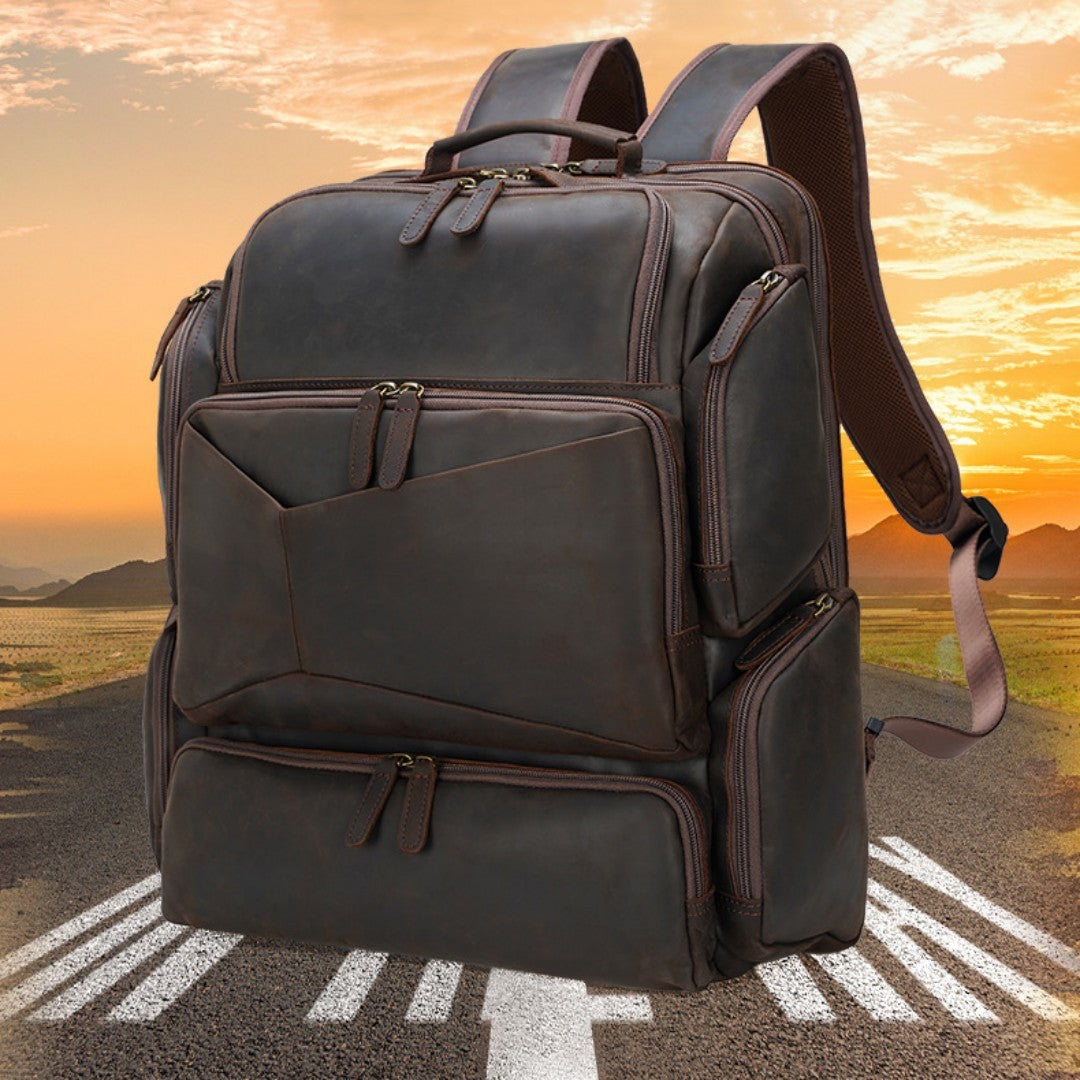 Brown leather backpack on a road with a scenic background