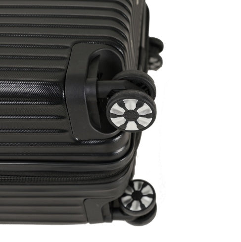 Close-up of a black suitcase with wheels on a white background