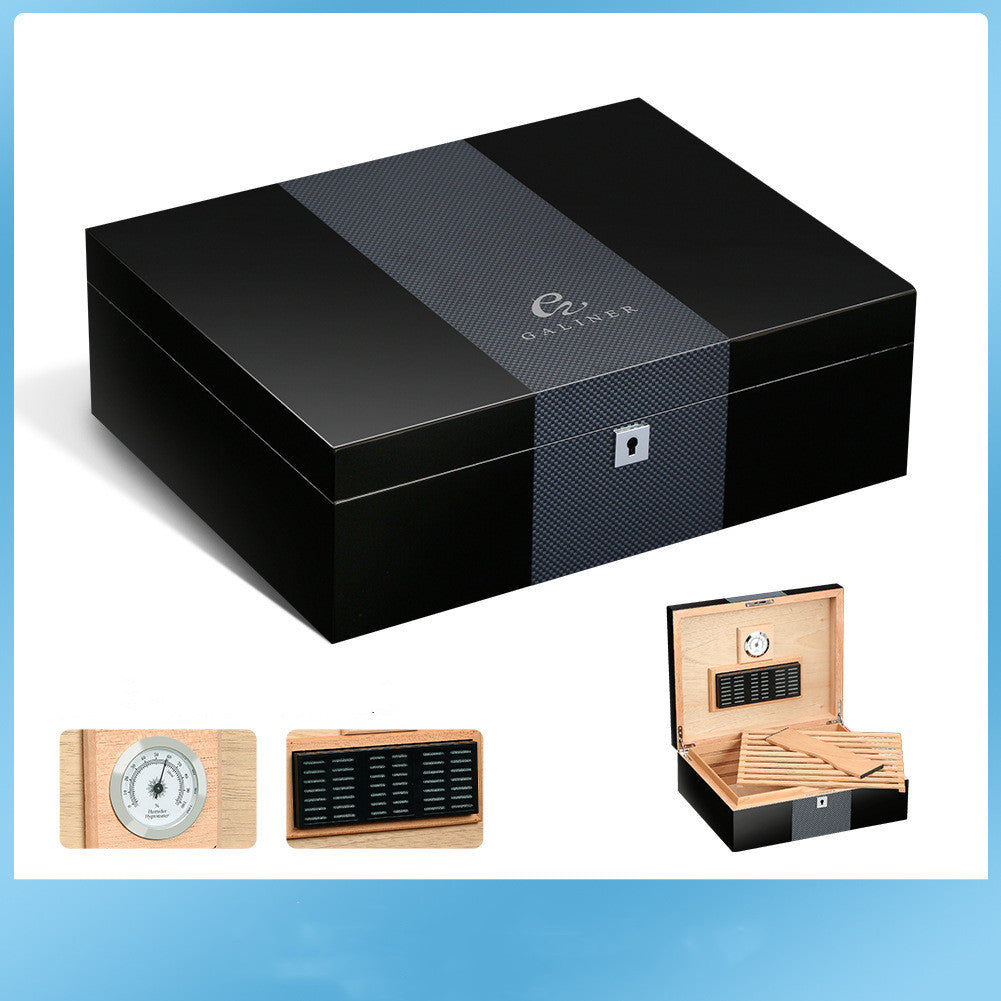 Black humidor with Galtsher logo, wooden accessories on a blue background