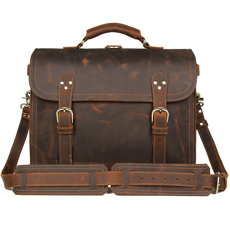 Brown leather briefcase with shoulder strap on a white background