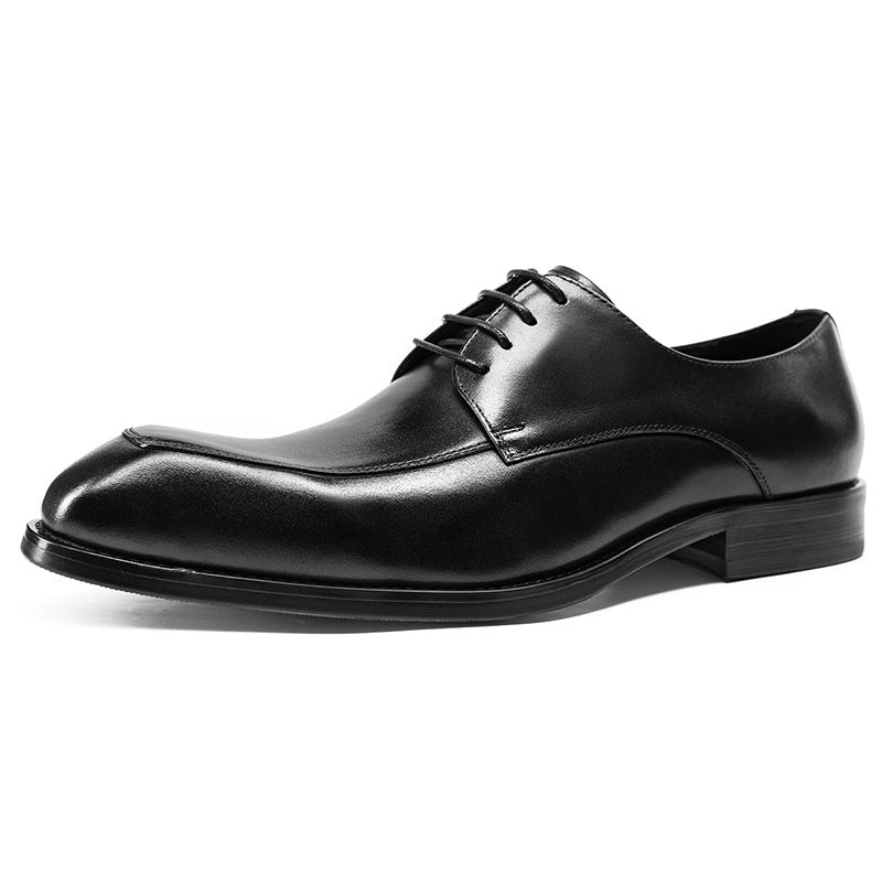 Black leather dress shoe on a white background
