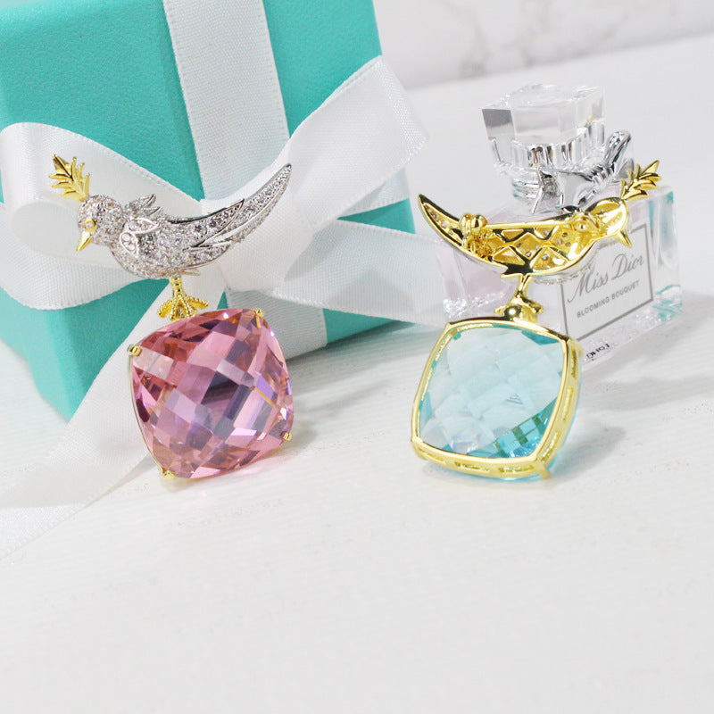 Two decorative items with gemstone-like designs on a white surface.