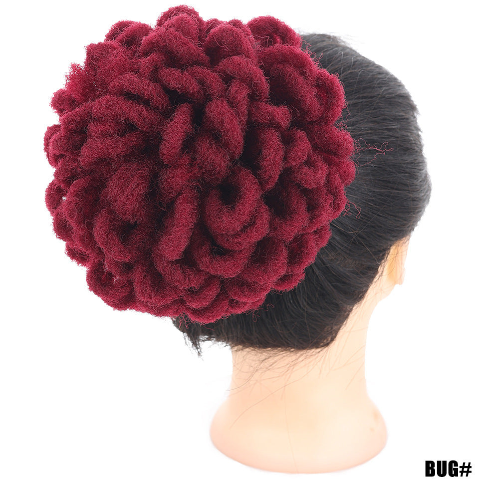 Red textured head wrap on a mannequin head with a white background