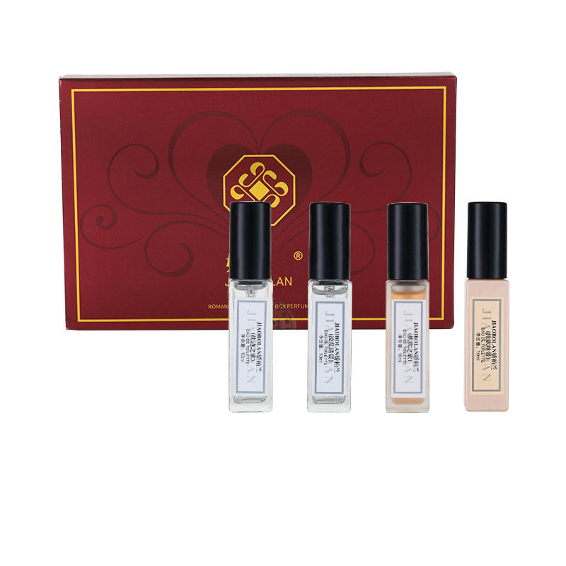 Set of four small bottles with black caps in front of a red and gold box on a white background
