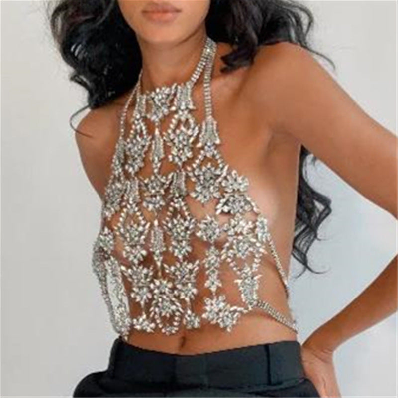 Woman wearing a silver beaded halter top against a plain background