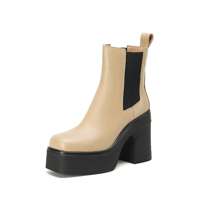 Beige Chelsea boot with a black platform sole on a white background