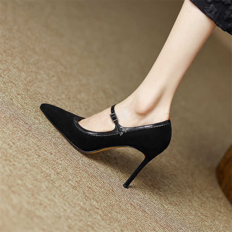 Black high-heeled shoes worn on a beige carpet