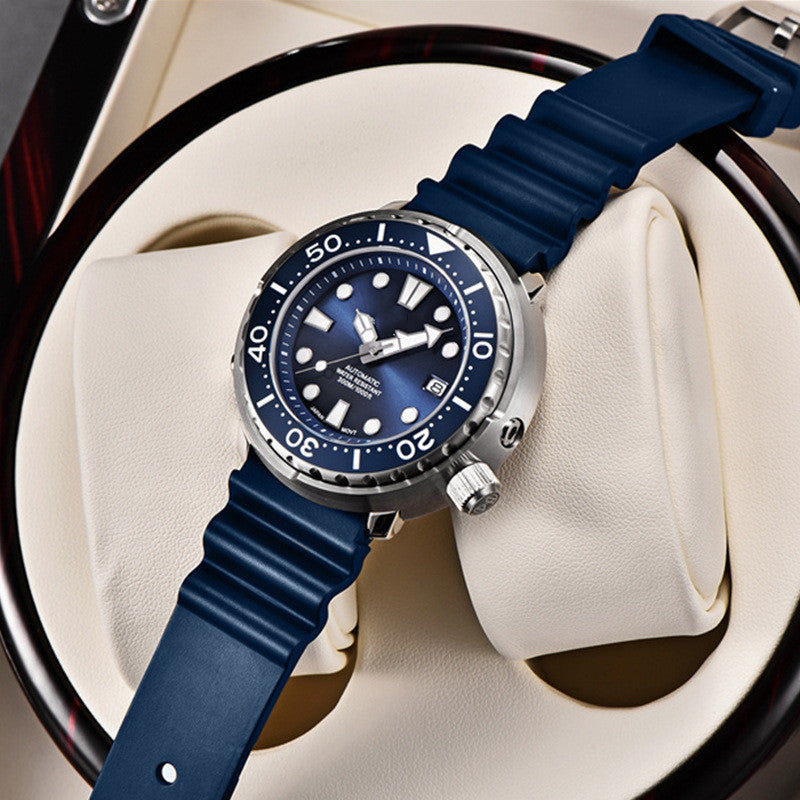 Blue wristwatch with a detailed face on a white cushion, likely in a display case.