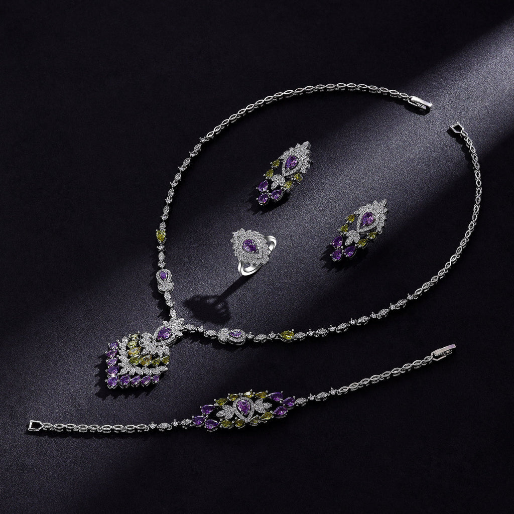 Jewelry set with necklace, earrings, and bracelet on a dark surface