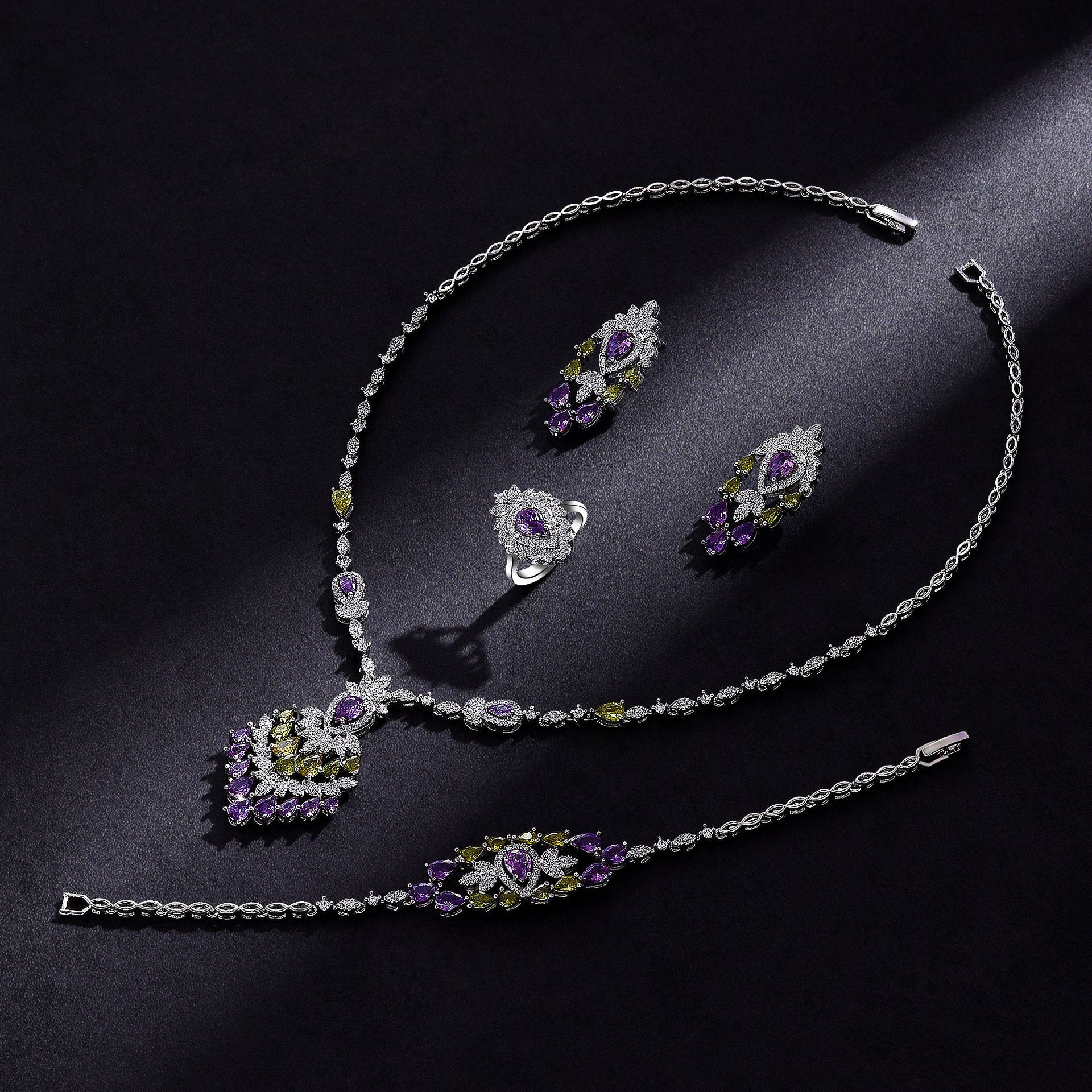 Jewelry set with necklace, earrings, and bracelet on a dark surface