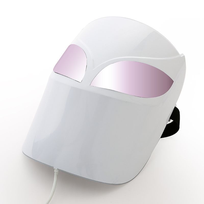 White facial mask with pink eye covers on a white background