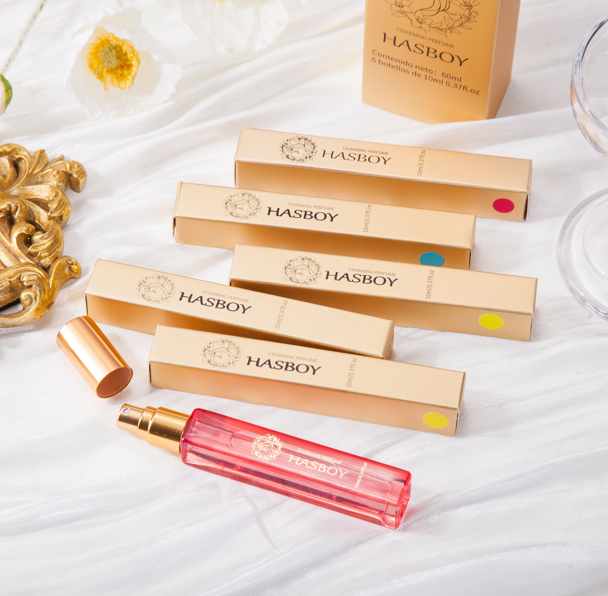 HASBOY lip gloss packaging and product on a white surface with decorative elements.