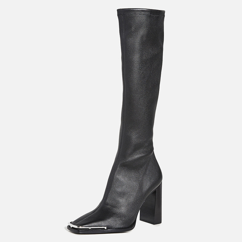 Black knee-high boot on a light gray background