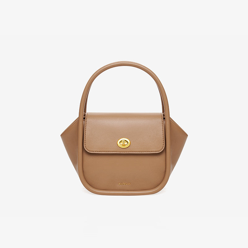 Tan handbag with a gold clasp on a light gray background