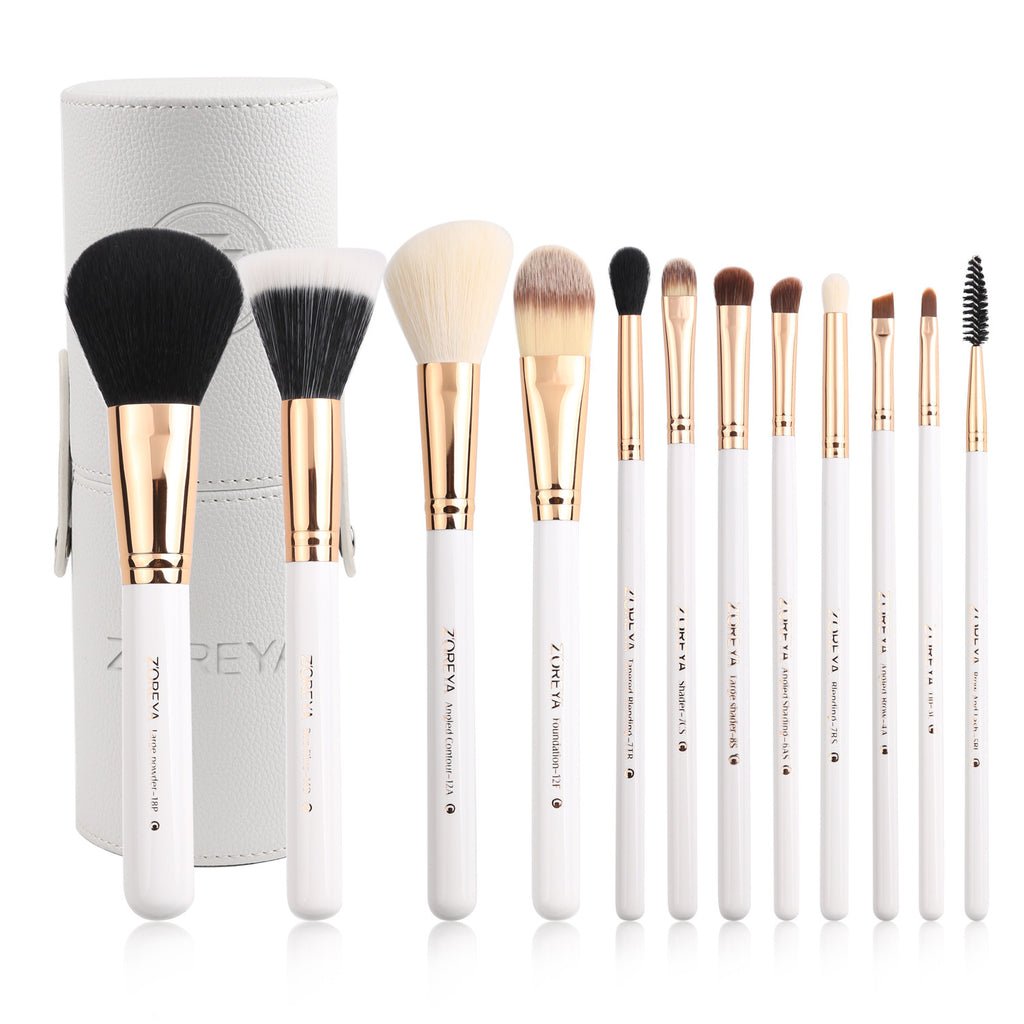Set of makeup brushes with a white handle and gold ferrule, displayed against a white background.
