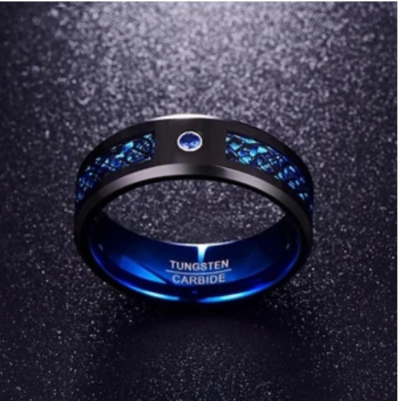 Tungsten carbide ring with blue stones on a dark textured background