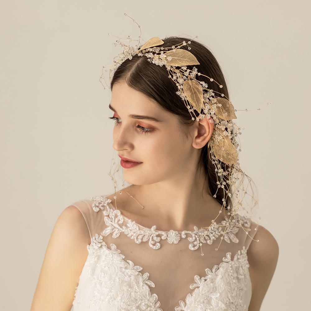 Woman wearing a decorative headpiece with gold leaves against a neutral background