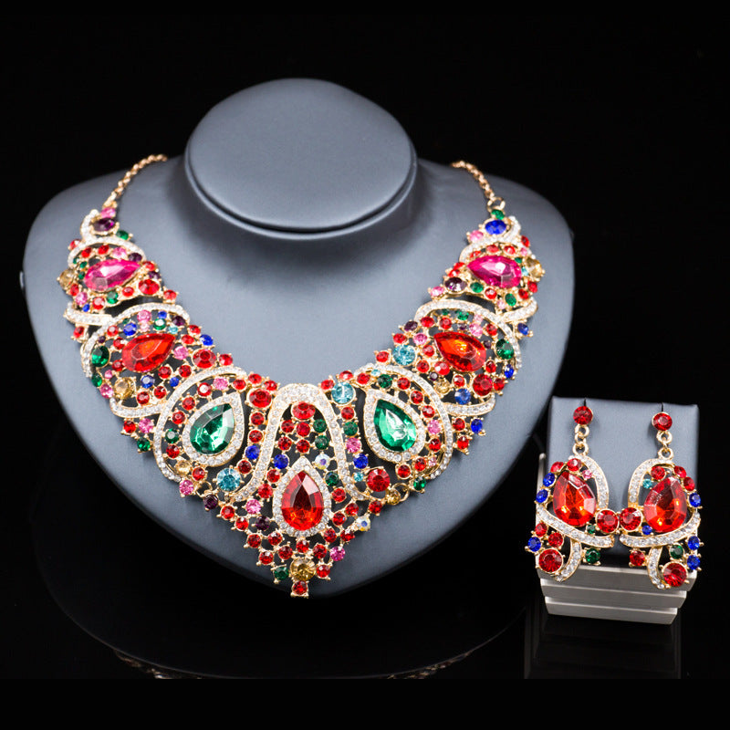 Colorful gemstone necklace and earrings set on a dark background