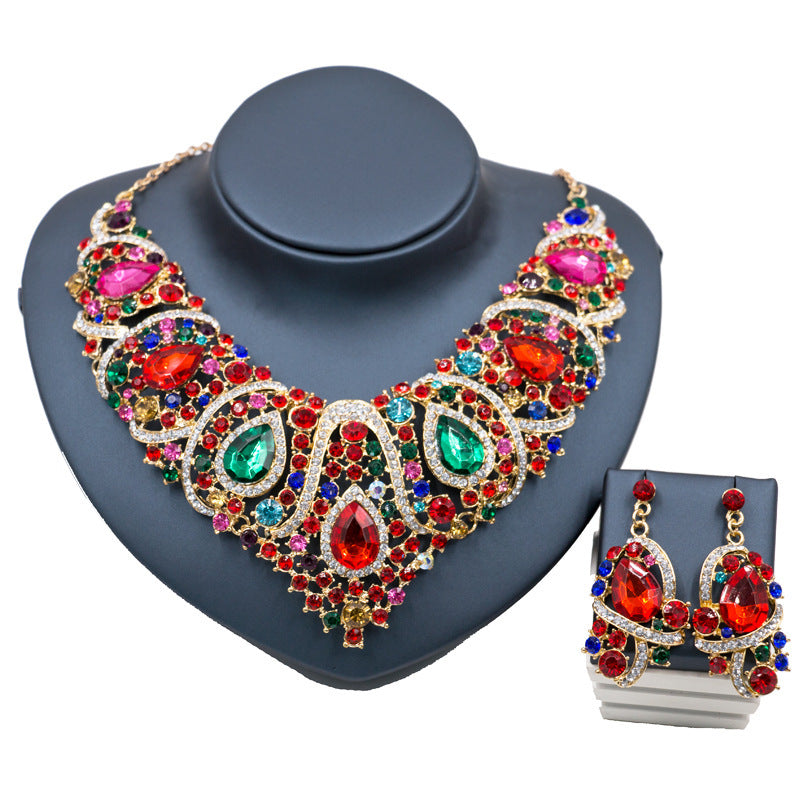 Colorful gemstone necklace and earrings on a gray stand