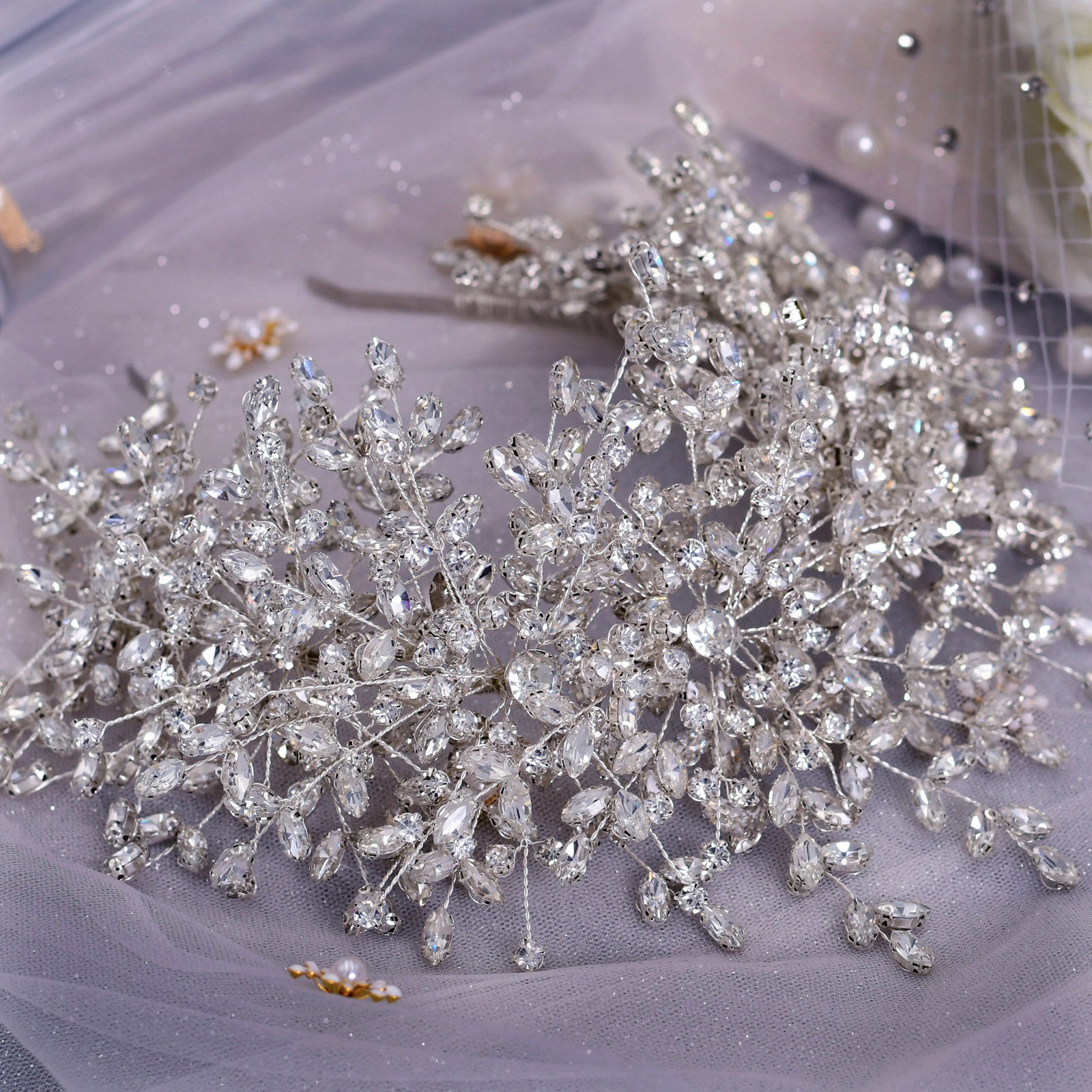 Silver hair vine with crystals on a soft fabric background