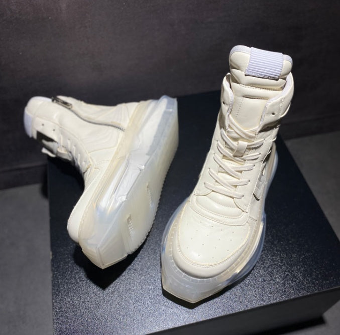 White high-top sneakers on a dark surface