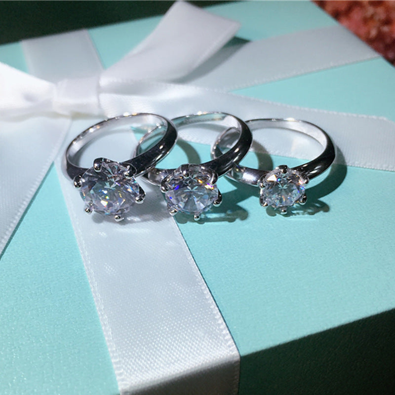 Three silver rings with gemstones on a Tiffany & Co. box