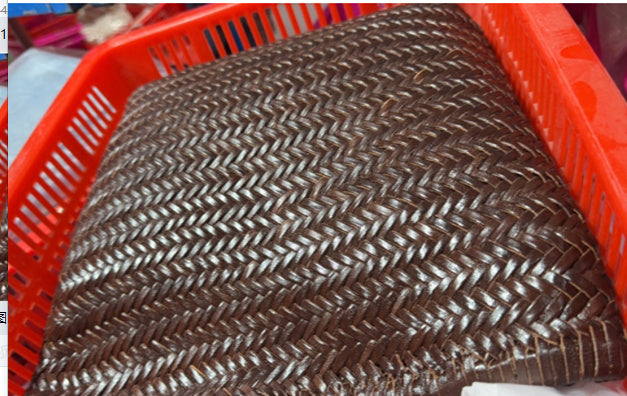 Close-up of a woven brown mat in a red basket