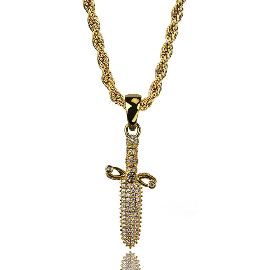 Gold necklace with a sword-shaped pendant on a white background