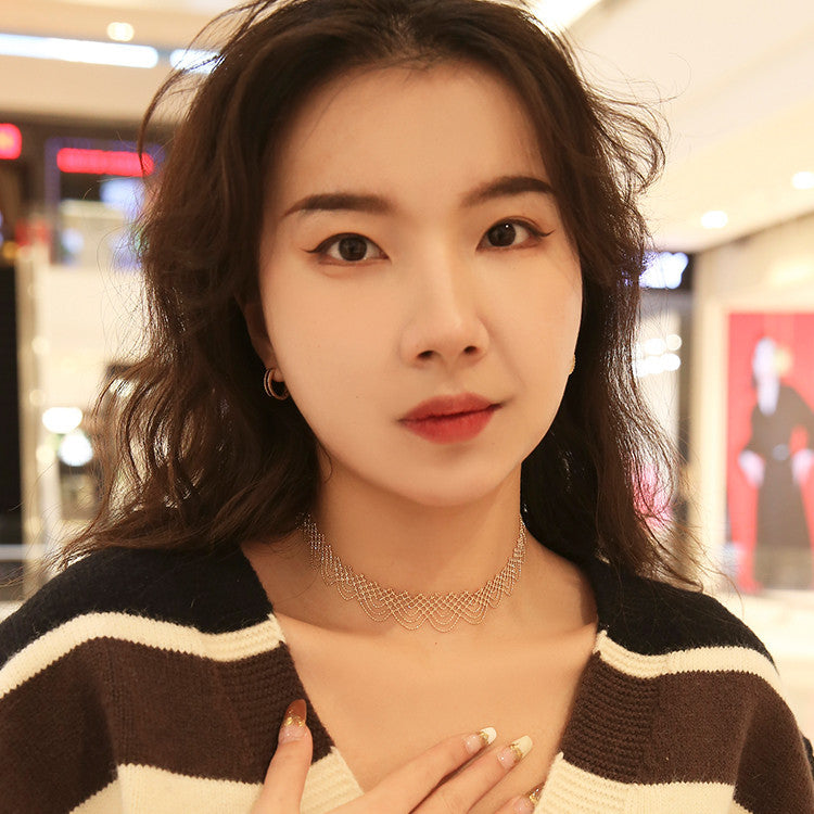 Woman wearing a striped sweater with a blurred indoor background
