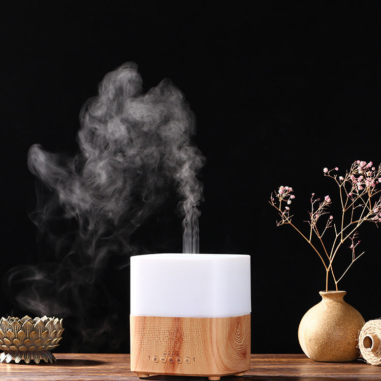 Wooden diffuser emitting steam on a dark background with decorative elements.
