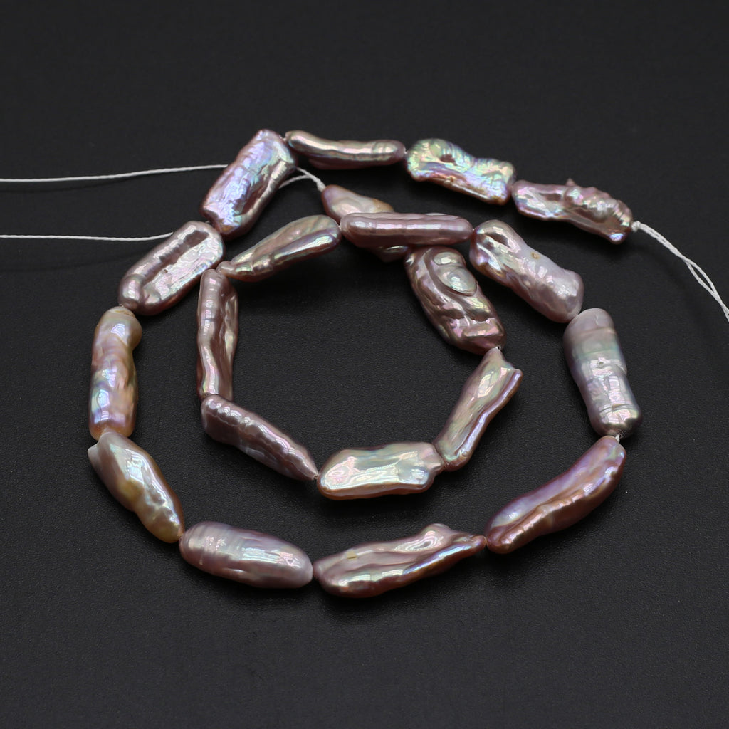 String of pink freshwater pearls on a dark background