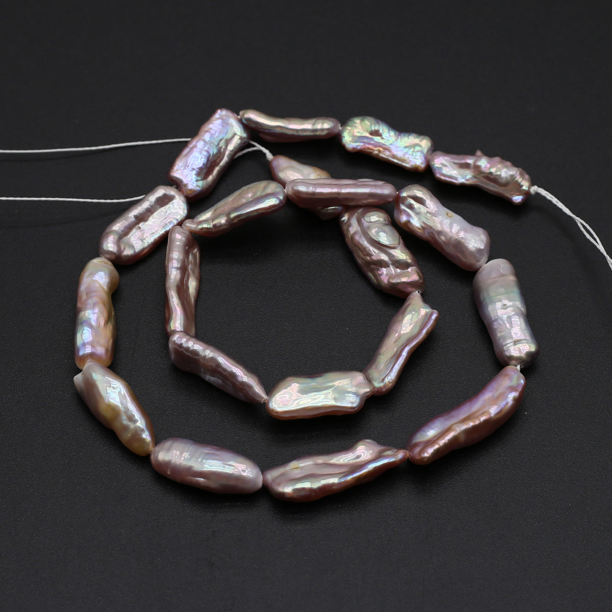 String of pink freshwater pearls on a dark background