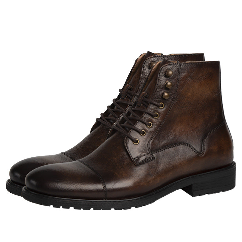 Pair of brown leather boots with laces on a white background