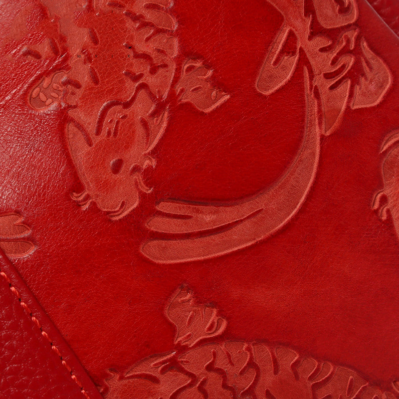 Red leather surface with embossed dragon design