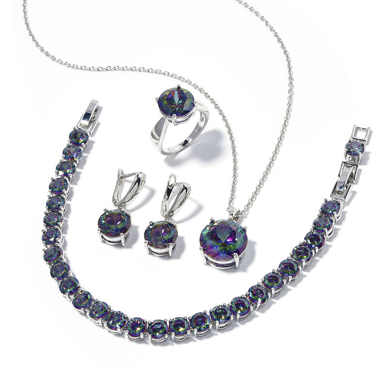 Jewelry set with necklace, bracelet, ring, and earrings featuring multicolored gemstones on a white background.