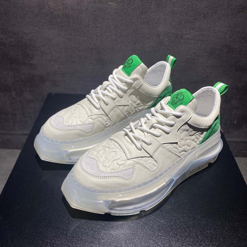 White sneakers with green accents on a dark surface