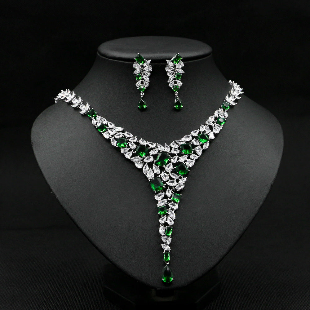 Jewelry set with necklace and earrings on a black stand