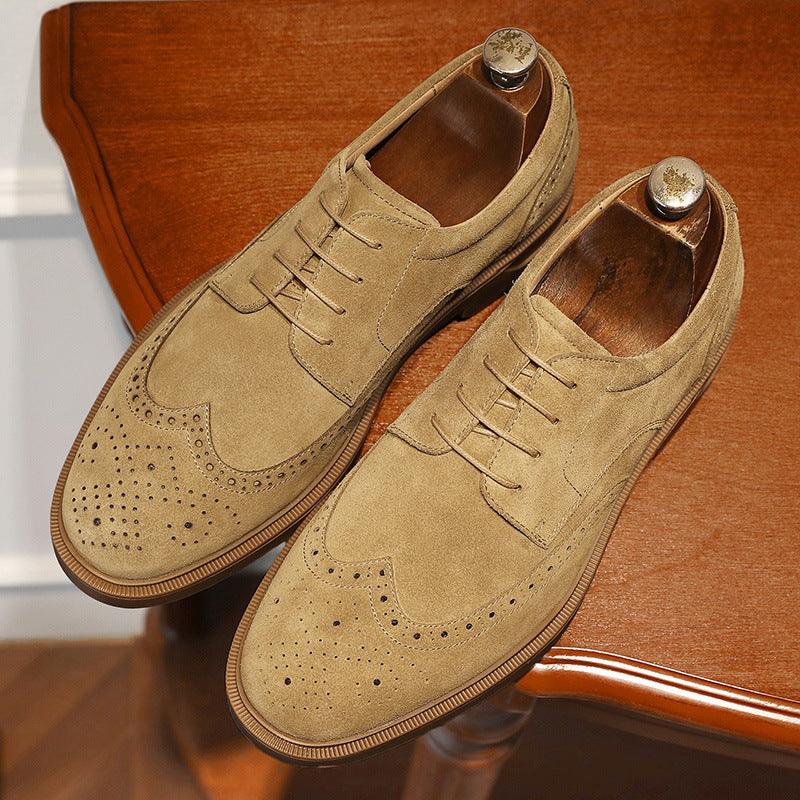 Pair of tan suede shoes on a wooden chair