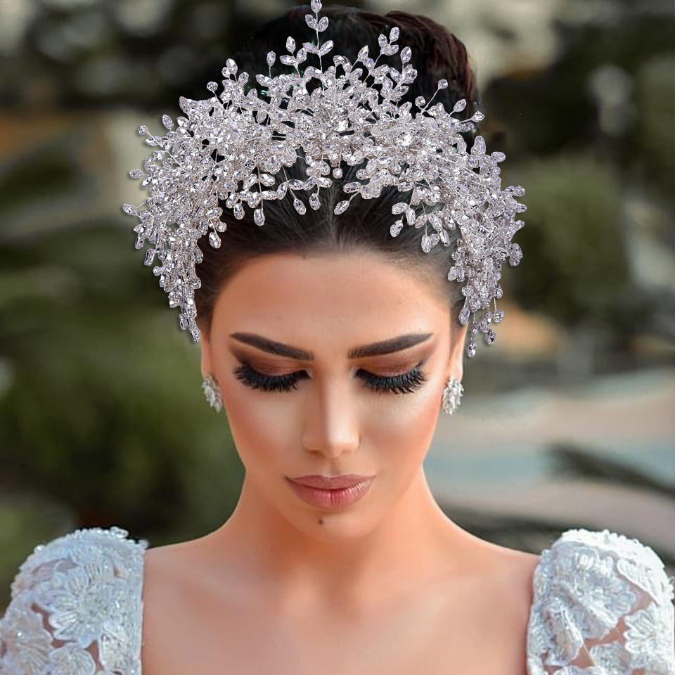Woman wearing a sparkling silver tiara with a blurred natural background