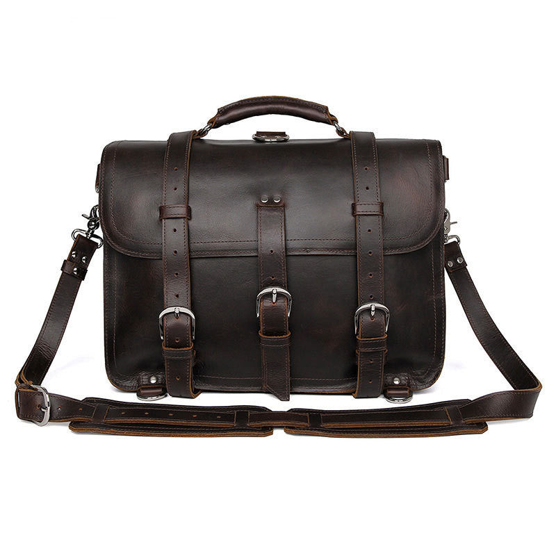 Dark brown leather satchel bag with straps on a white background