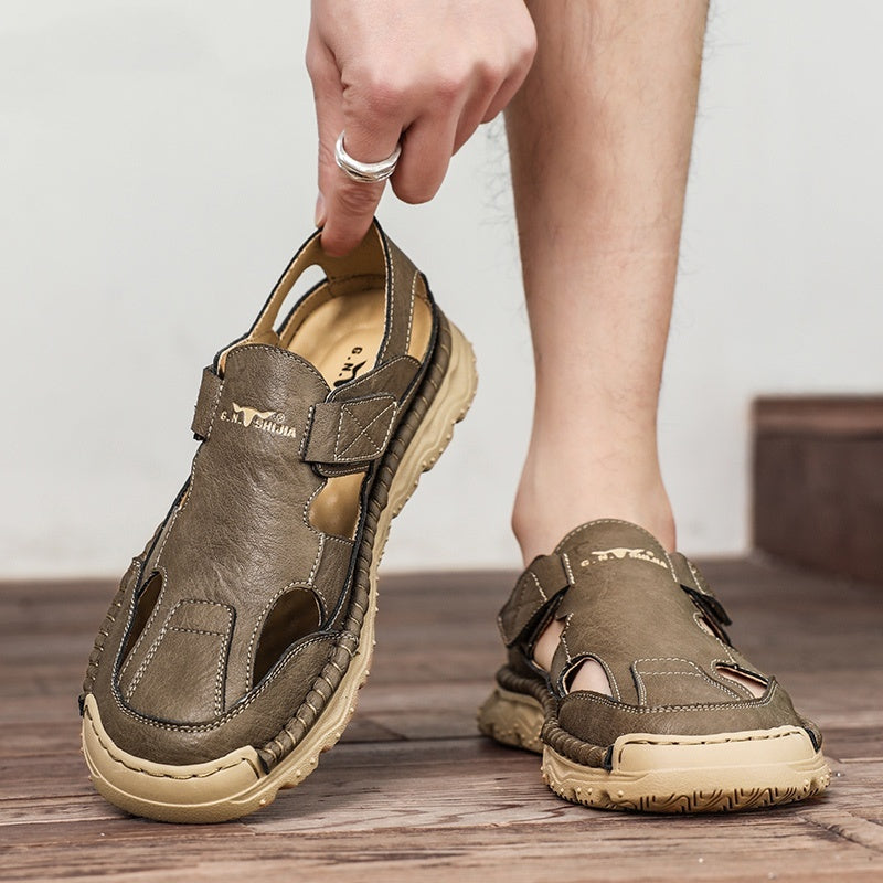 Brown sandals being held up with a neutral background