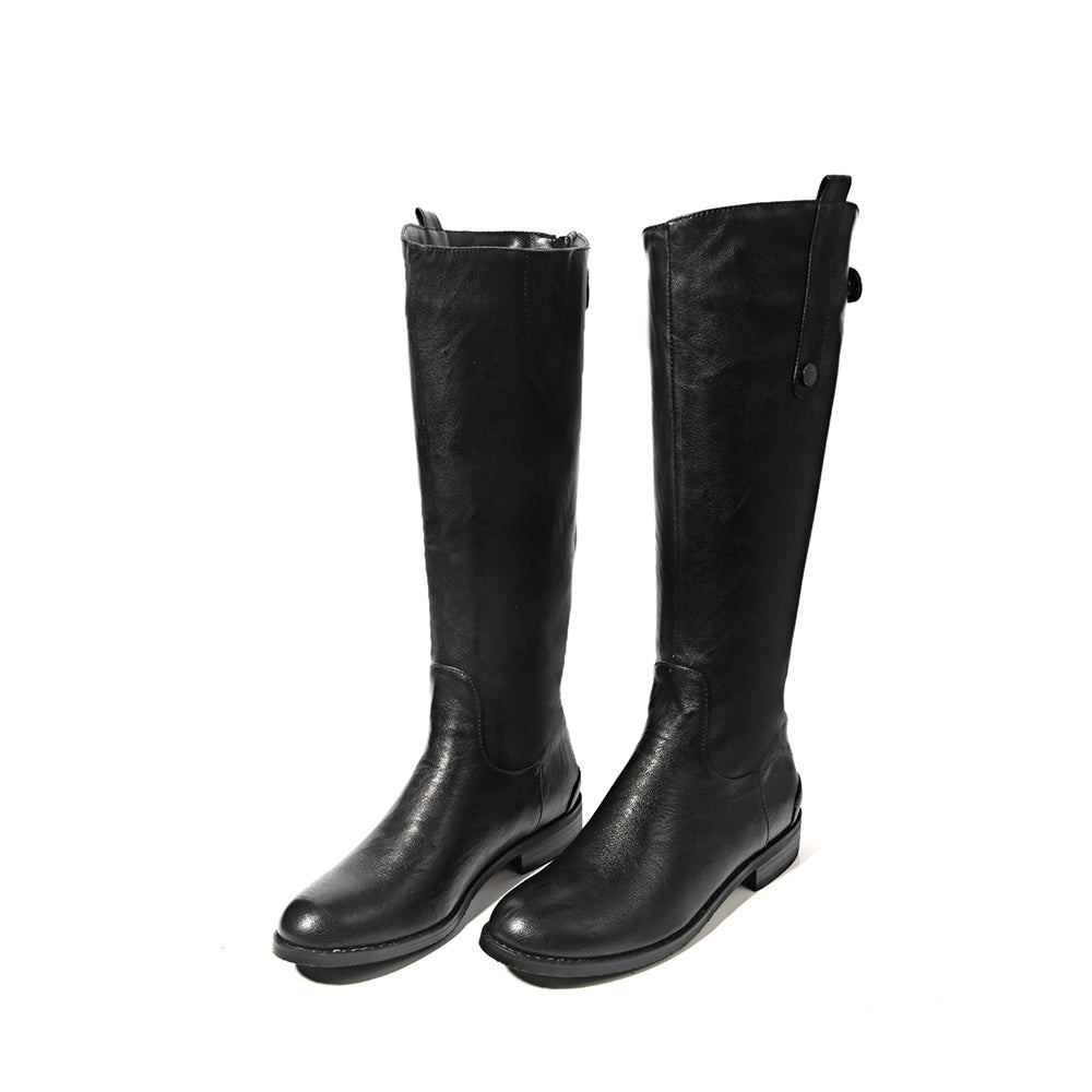 Pair of black riding boots on a white background