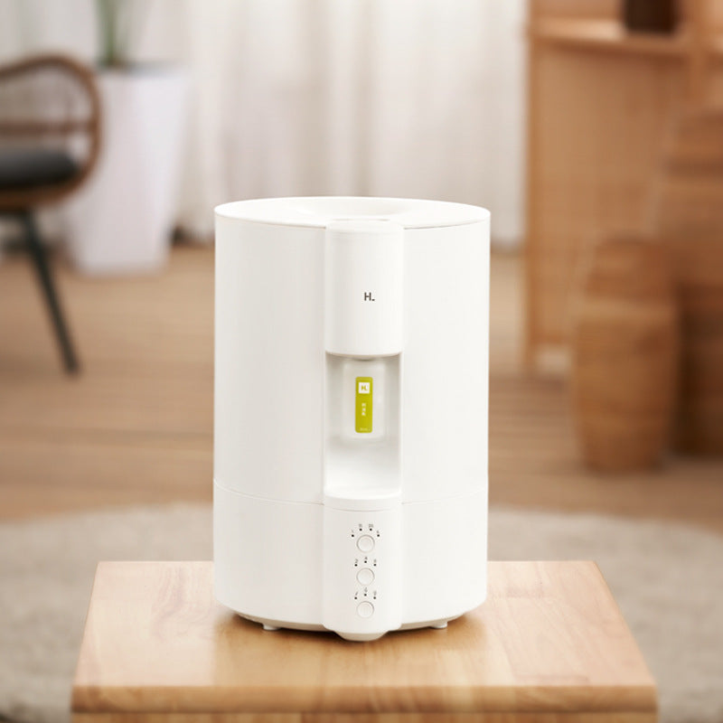 White humidifier on a wooden table with a blurred indoor background