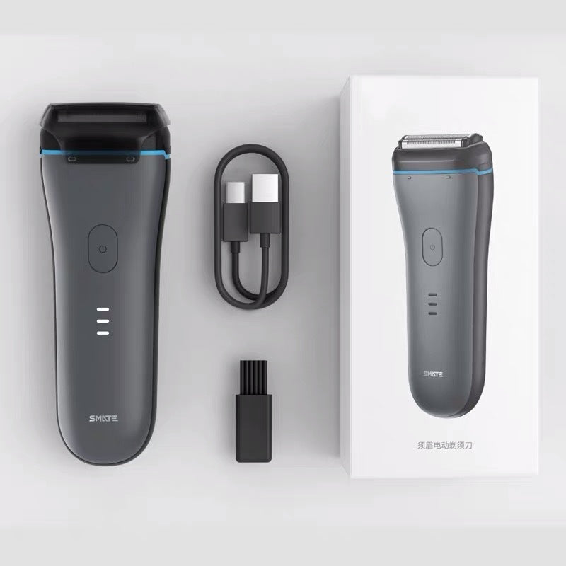 Electric shaver with charging cable, cleaning brush, and packaging on a white background