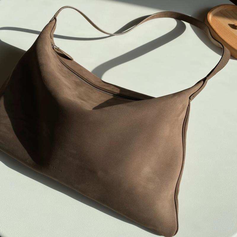 Brown leather handbag on a light background